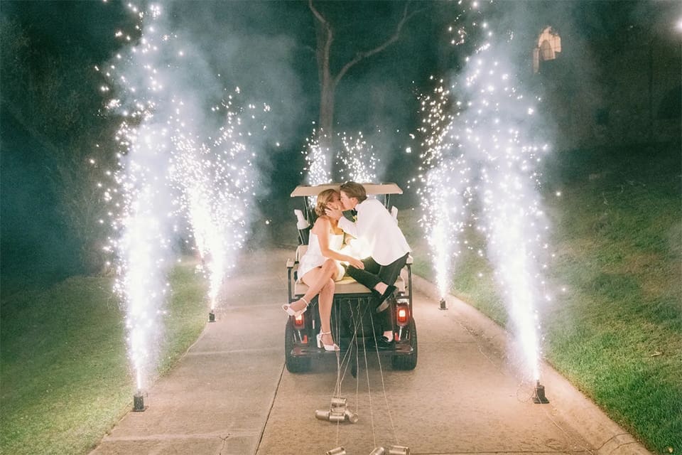 A couple celebrating at their wedding with fireworks